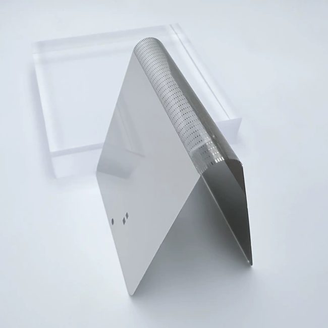 Side view of a thin folded metal support plate showing the precision patterned bending zone