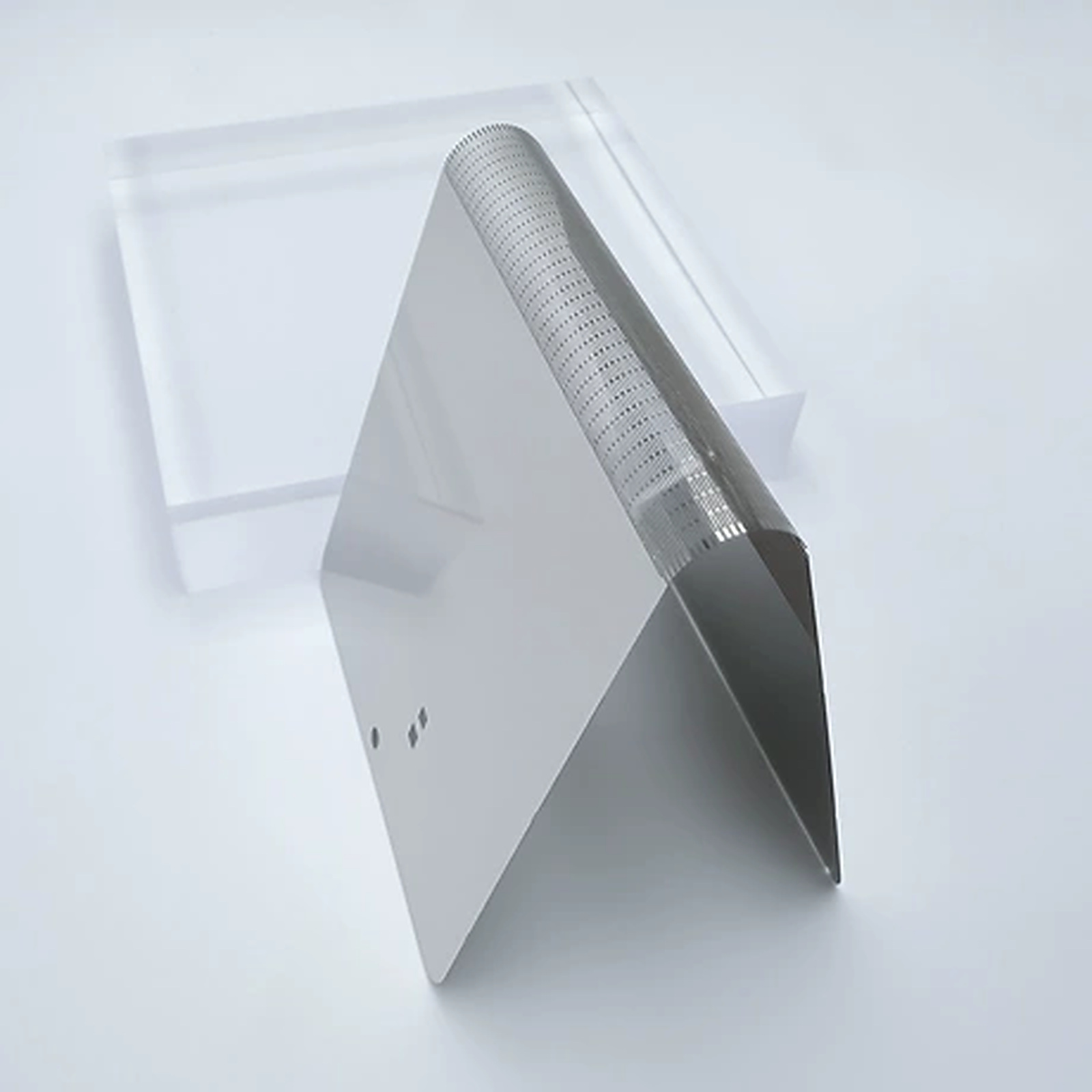 Side view of a thin folded metal support plate showing the precision patterned bending zone