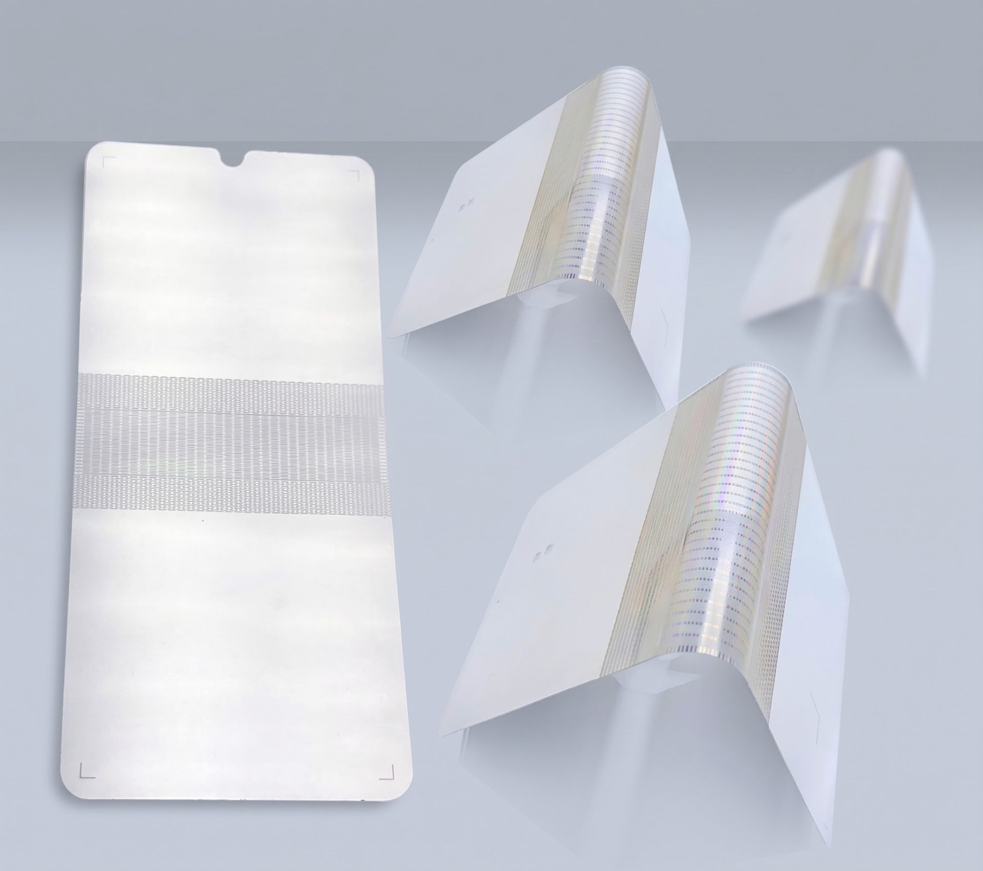Flat and formed thin metal support plates showing foldable-smartphone manufacturing stages