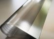 Close-up of fine etched micro-slots in a thin titanium support plate for foldable electronics